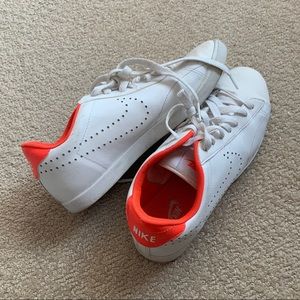 White Nike low tops with orange detailing